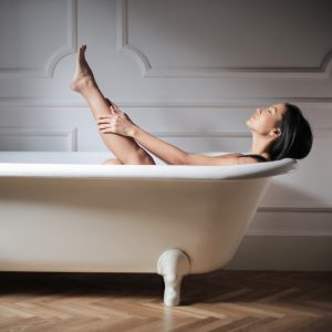 Galerie Foto - Frau in der Badewanne, ein Bein hochgetreckt